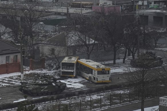 Russian army tanks move down a street on the outskirts of Mariupol, Ukraine, on March 11.