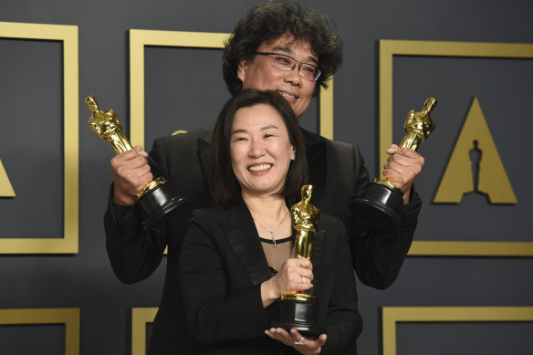 Kwak Sin Ae, front, and Bong Joon Ho, winners of the award for best picture for Parasite. pose in the press room.