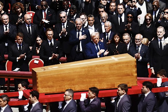 The coffin of Pope Francis is carried in front of dignitaries.