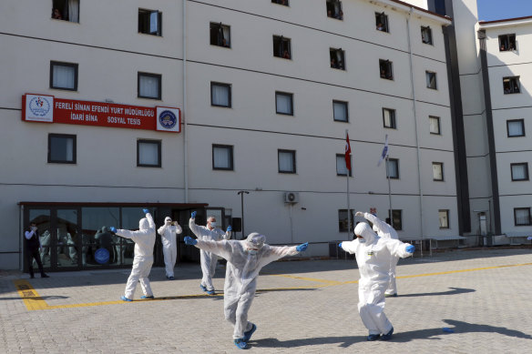 Turkish health officials perform an impromptu dance to celebrate the end of quarantine for health workers returning  from Kazakhstan and Russia.