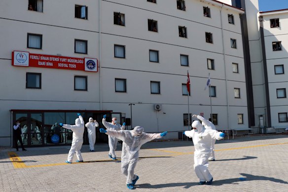 Turkish health officials perform an impromptu dance to celebrate the end of quarantine for health workers returning  from Kazakhstan and Russia.