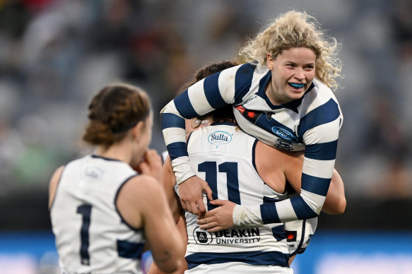 Mikayla Bowen, Meghan McDonald, and Georgie Prespakis celebrate on the final siren.