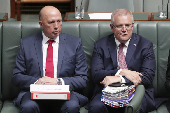 Peter Dutton and Scott Morrison during Question Time in March 2020, just before Dutton contracted COVID on a trip to the US. 