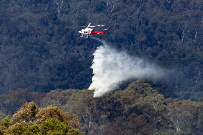 A water bomber douses fire near Warrak on Wednesday.