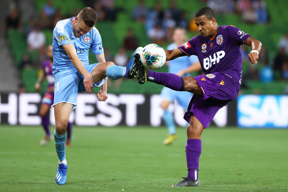 Melbourne City's Craig Noone and James Meredith of the Glory battle for the ball on Saturday night.