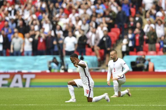 England’s Raheem Sterling, left and  Luke Shaw take the knee during the Euro 2020 match between England and Germany at Wembley Stadium in London on June 29.