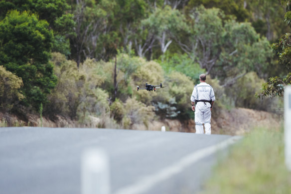 Police operating a drone to search the property outside Bungonia