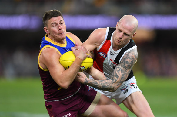 The Lions’ Dayne Zorko is tackled by Zak Jones. Both players were injured.