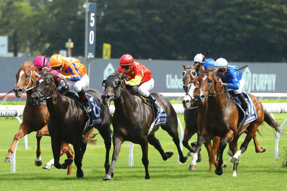 Zac Purton (red cap) swoops late on Artorius  in the Canterbury Stakes.
