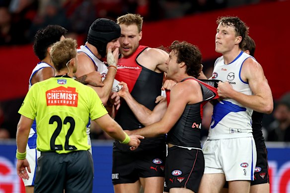 Bloodied: Tristan Xerri and Andrew McGrath clash at Marvel Stadium on Saturday night.