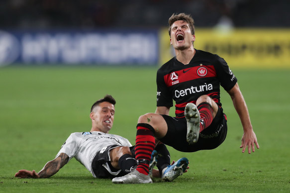 Wanderers' Pirmin Schwegler grimaces after being brought down by Javier Cabrera at Bankwest Stadium on Friday night.