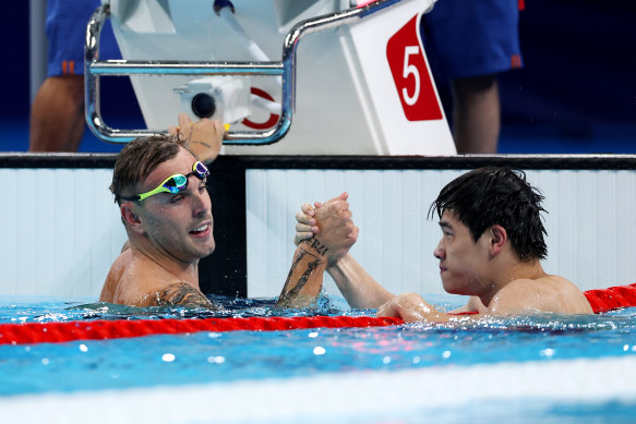 Kyle Chalmers congratulates Pan Zhanle on his record-breaking swim.