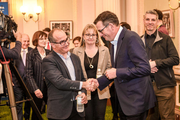 Premier Daniel Andrews shakes hands with outgoing deputy premier James Merlino. His preferred deputy, Jacinta Allan, is pictured centre.