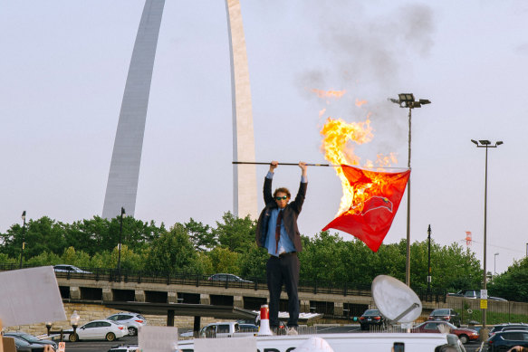 Peter McIndoe burning a flag for the St Louis Cardinals baseball team in St Louis, Missouri, during a satirical protest of the baseball team’s logo in July 2021.