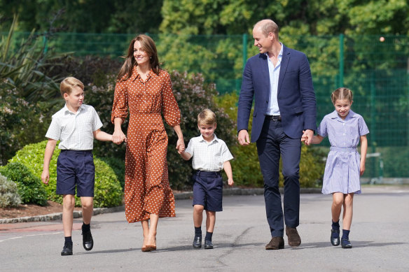 Prince George, Princess Charlotte and Prince Louis (centre), accompanied by their parents William and Catherine, arrive for a settling-in afternoon at Lambrook School last week. 