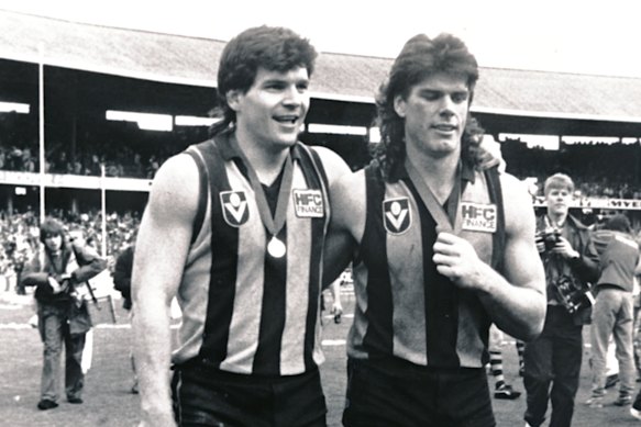 Gary Ayres (right) after winning his second Norm Smith Medal in 1988 does a victory lap with AFL Legend Jason Dunstall.