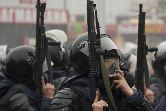 Riot police officers stand ready to stop demonstrators during a protest in Almaty, Kazakhstan.