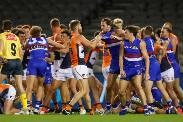 Bulldogs and Giants players wrestle during an all-in melee on Friday night.