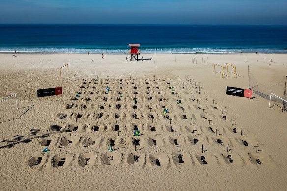 An aerial view of symbolic graves on the beach.