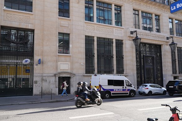 Police stand outside the Bank of America building in Paris on Saturday.