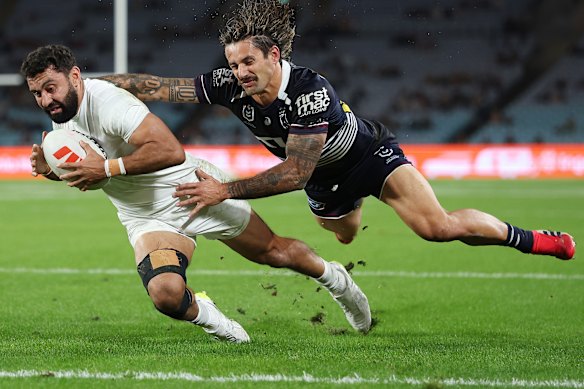 Alex Johnston beats Jesse Arthars to score the first of his four tries on Thursday night.