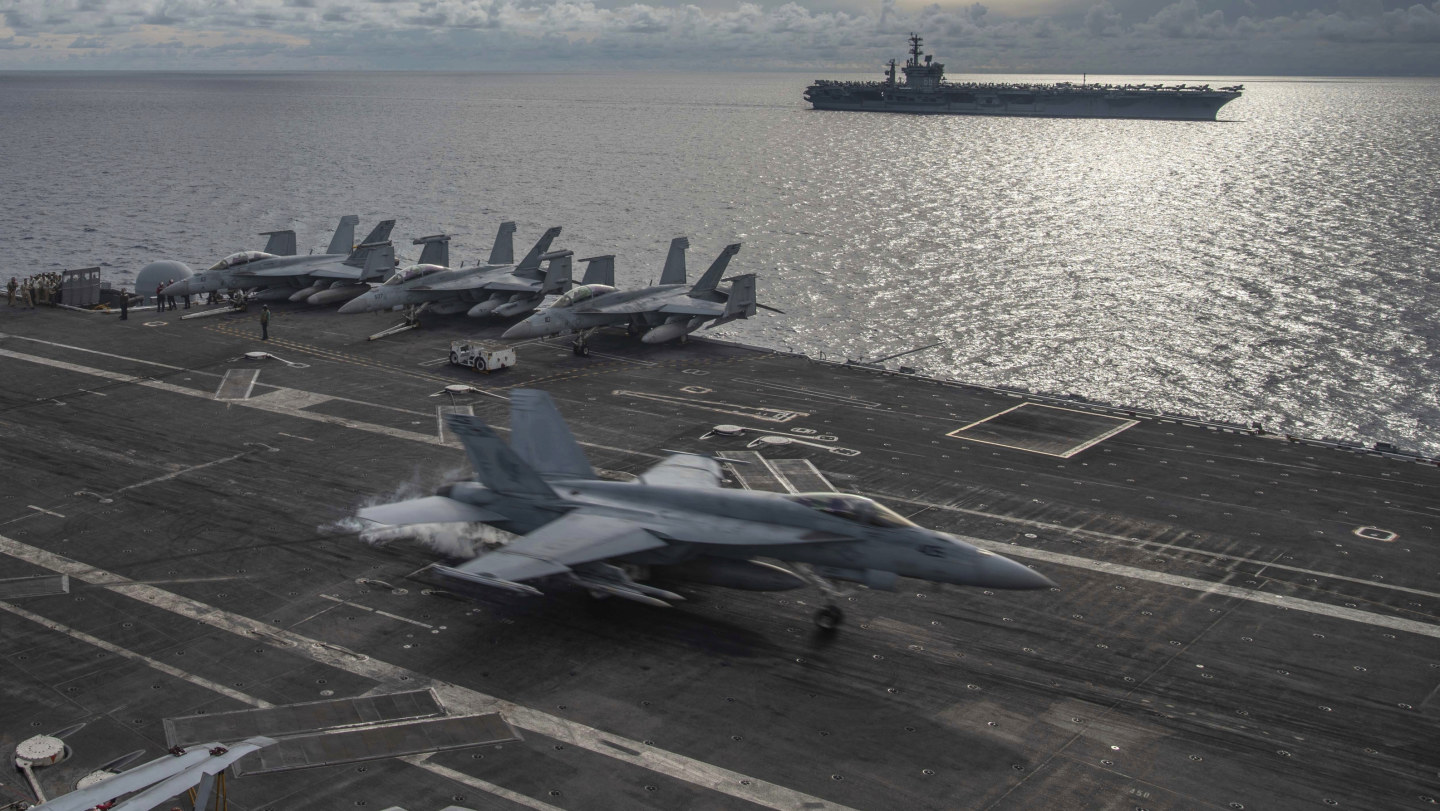 US aircraft carriers the USS Ronald Reagan and the USS Nimitz on patrol in the South China Sea.  Washington is under pressure from some quarters to make a completely unambiguous commitment to fight for Taiwan.