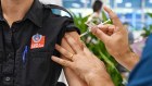 An emergency worker receives a COVID-19 vaccine in Sydney.