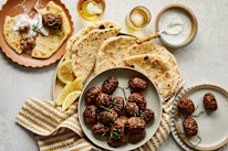 Beef koftas with pita bread and minted yoghurt.