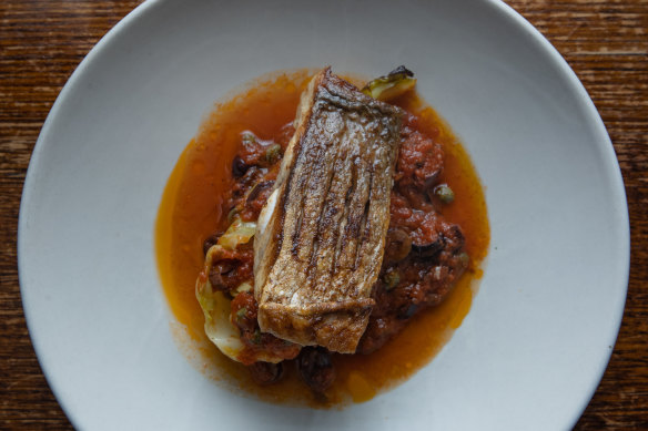 Crisp-skinned baby snapper with puttanesca sauce, buttery cabbage, and olives.