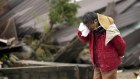 A man cries as a body of his family member was found in a collapsed house caused by the powerful earthquake in Suzu, Ishikawa Prefecture.