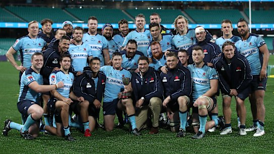 The Waratahs pose for a photo after their emphatic win over the Queensland Reds on Saturday. 