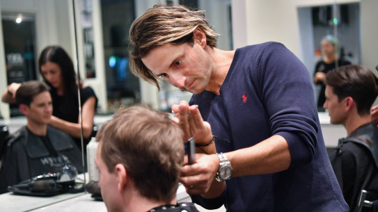 Salon owner Joey Scandizzo, pictured pre-lockdown, is worried about losing staff if the hairdressing industry were to mandate vaccines.