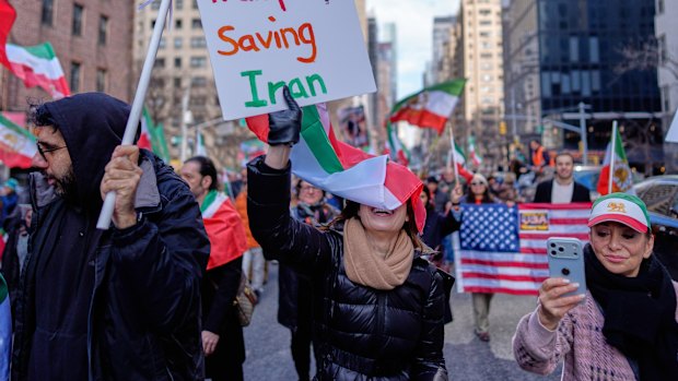 People hold signs in New York thanking President Donald Trump. 