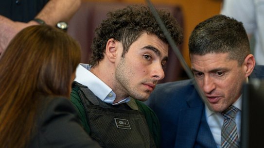 Luigi Mangione, accused of fatally shooting the UnitedHealthcare CEO Brian Thompson in New York City, confers with attorney’s during a court hearing.
