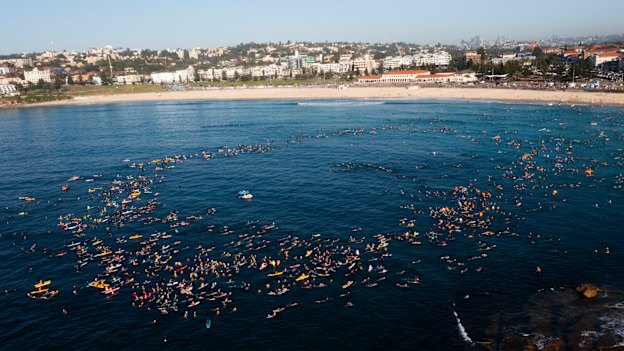 Large numbers of people join a paddle out at Bondi Beach, five days after a terrorist attack in which 15 innocent victims were killed and many more were wounded.