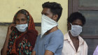 Indians standing in a queue outside a hospital wear masks as a precautionary measure against the Nipah virus at the Government Medical College hospital in Kozhikode, in the southern Indian state of Kerala.