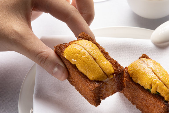 Lee Ho Fook’s prawn toast comes with luxurious touches, like a sea urchin on top.