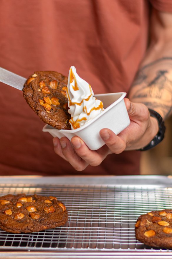 Warm cookies are served with soft serve. 
