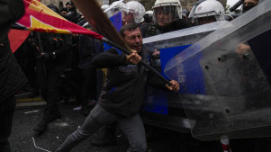 Union members clash with Turkish anti riot police officers as they march during Labor Day celebrations in Istanbul, Turkey.