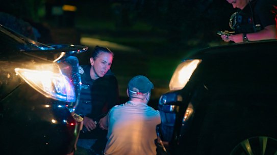 Police officer Stacey Dwyer speaks with a man arrested for possessing methamphetamine.