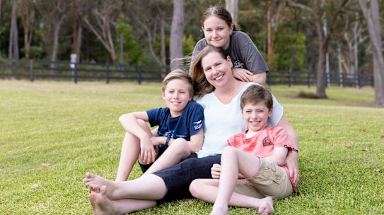 Bronwyn Grout is an ovarian cancer ‘Super Survivor’ 15yrs after her diagnosis. pictures show her at her Wyee Point home with her children Emily, 13yrs, and twin boys Thomas (Red tshirt) and Daniel (Dark Blue tshirt) age 11yrs. 2nd Dec 2022 . pic by Peter Stoop/SMH .