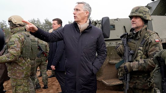 NATO Secretary General Jens Stoltenberg gestures while speaking to Poland’s troops during his visit to Adazi Military base in Kadaga, Latvia.