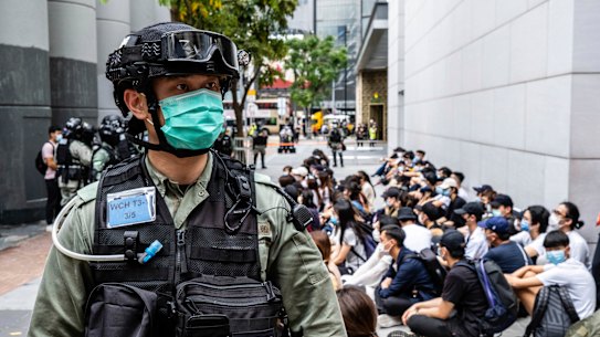 Riot police round up a group of protesters during a demonstration on Wednesday May 27. 