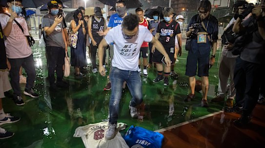 A demonstrator stomps on a LeBron James jersey during the rally.