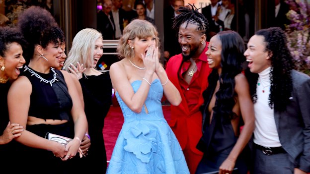 Taylor Swift with dancers and crew attend Taylor Swift: The Eras Tour premiere in Los Angeles on October 11.