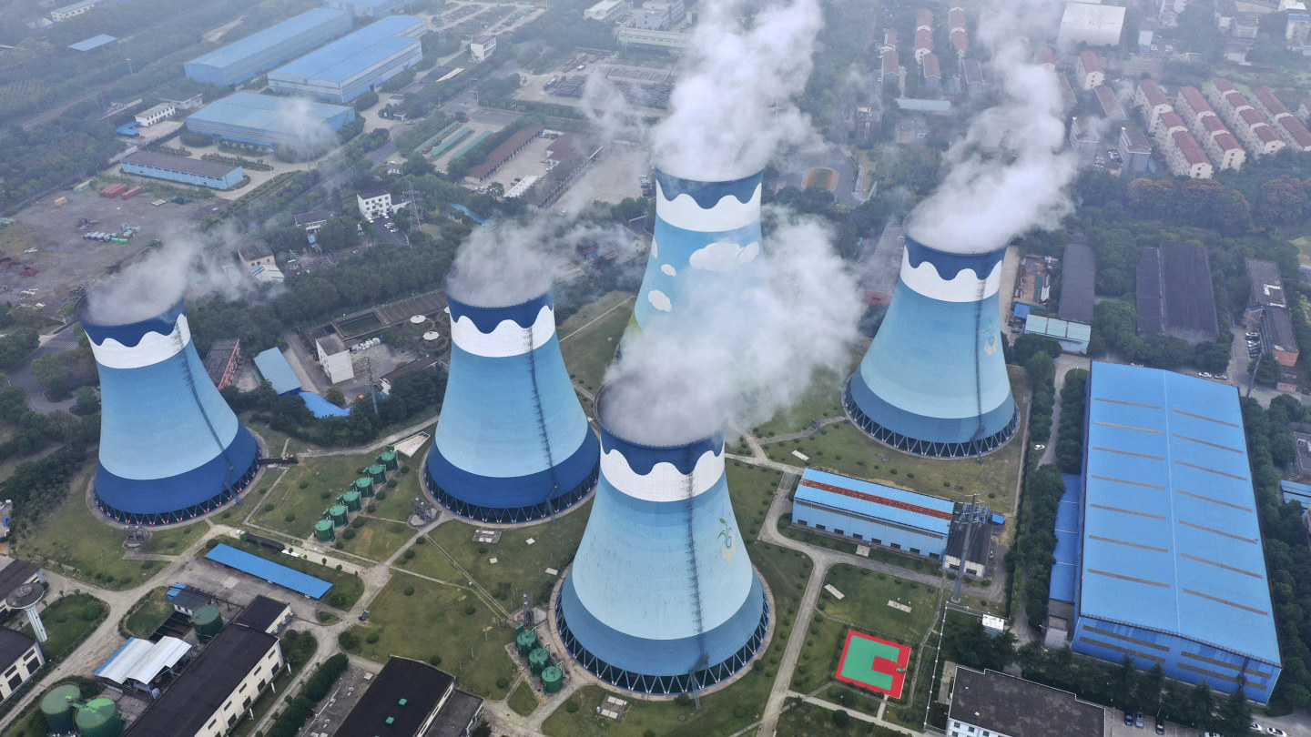 Steam billows out of the cooling towers at a coal-fired power station in Nanjing in east China. 