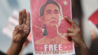 The three-finger salute, a symbol of resistance in south-east Asia, and a poster of jailed leader Aung San Suu Kyi. 