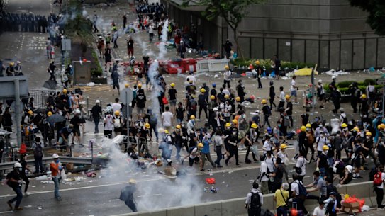 Riot police fire tear gas to protesters outside the Legislative Council in Hong Kong, Wednesday, June 12, 2019. Hong Kong police have used tear gas and high-pressure hoses against thousands of protesters opposing a highly controversial extradition bill outside government headquarters.
