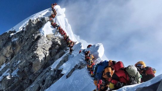 A photo of climbers lining up at the summit of Mount Everest has sparked a debate over deaths and traffic jams.