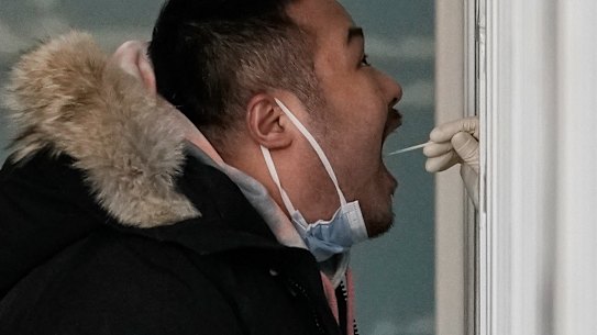 A man is tested in Beijing. China reported more than 100 new COVID-19 cases for a seventh day on Tuesday.